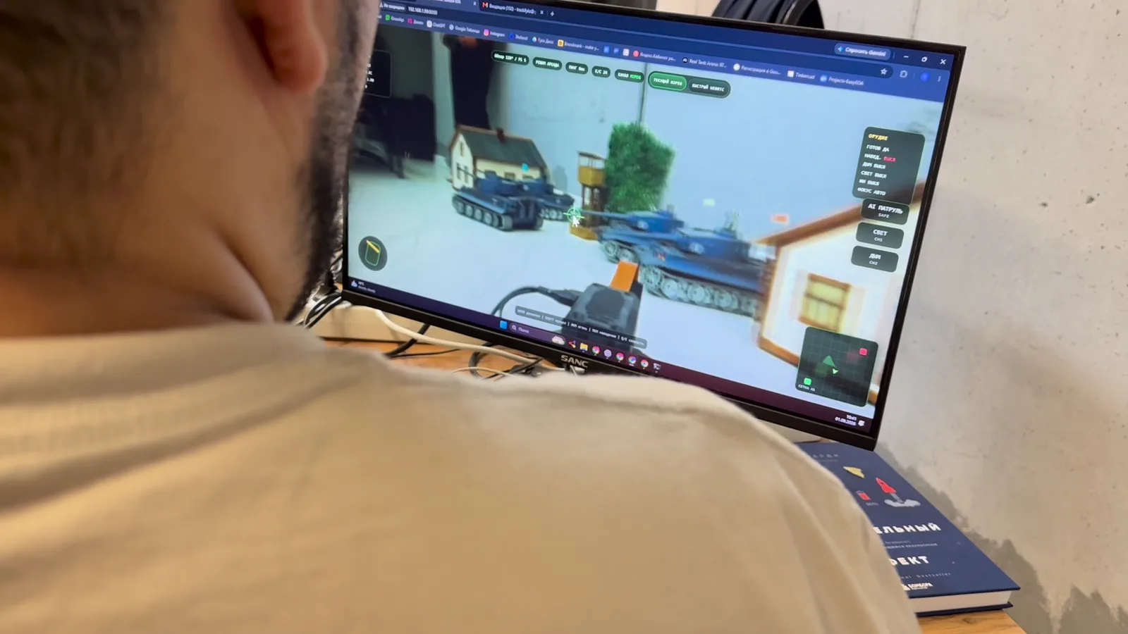 Operator controlling a physical tank from a computer using its live onboard video